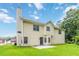 A spacious backyard featuring a well-maintained lawn and a neutral-colored two-story home with black trim at 1029 Chaterly Ct, Riverdale, GA 30296