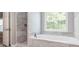 Bathroom featuring soaking tub, walk-in shower, and large window at 1029 Chaterly Ct, Riverdale, GA 30296