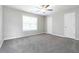 Spacious carpeted bedroom with ceiling fan and natural light from window at 1029 Chaterly Ct, Riverdale, GA 30296