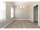 Dining room featuring light wood floors, a chandelier and neutral paint at 1029 Chaterly Ct, Riverdale, GA 30296