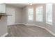 Cozy eat-in kitchen space with light wood floors, large windows and neutral paint at 1029 Chaterly Ct, Riverdale, GA 30296