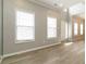 Living room featuring light wood floors, with large windows, lots of light and neutral paint at 1029 Chaterly Ct, Riverdale, GA 30296