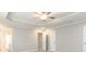 Spacious main bedroom features tray ceiling, ceiling fan, and two doorways at 1029 Chaterly Ct, Riverdale, GA 30296