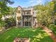 Expansive backyard with lush green lawn, screened porch, and brick accents at 2461 Fernleaf Nw Ct, Atlanta, GA 30318
