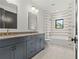 Bathroom features double vanity, soaking tub with tile surround, and modern fixtures at 2461 Fernleaf Nw Ct, Atlanta, GA 30318