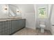 Charming bathroom features modern fixtures, granite countertop, and eye-catching tile flooring at 2461 Fernleaf Nw Ct, Atlanta, GA 30318