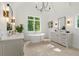 Bright bathroom features a soaking tub beneath a picture window between and vanities at 2461 Fernleaf Nw Ct, Atlanta, GA 30318