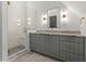 Modern bathroom features a glass enclosed shower, gray cabinets, and sleek fixtures at 2461 Fernleaf Nw Ct, Atlanta, GA 30318