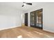 Bedroom with hardwood floors and black french doors at 2461 Fernleaf Nw Ct, Atlanta, GA 30318