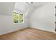 Bedroom features hardwood flooring, a vaulted ceiling, and a large picture window at 2461 Fernleaf Nw Ct, Atlanta, GA 30318