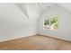 Bright bedroom with sloped ceiling features hardwood flooring and a large picture window at 2461 Fernleaf Nw Ct, Atlanta, GA 30318