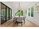 Elegant dining room bathed in natural light features wood floors and views of the serene outdoor scenery at 2461 Fernleaf Nw Ct, Atlanta, GA 30318