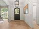 Entry foyer showcasing hardwood flooring, stylish light fixture, and an arched front door at 2461 Fernleaf Nw Ct, Atlanta, GA 30318
