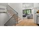 Bright foyer with wood floors and a staircase leads into the main living space at 2461 Fernleaf Nw Ct, Atlanta, GA 30318