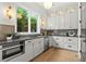 Beautiful kitchen features modern appliances, stone countertops, wood floors, and ample cabinet space at 2461 Fernleaf Nw Ct, Atlanta, GA 30318