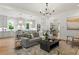 Open-concept living room with hardwood floors, recessed lighting, and kitchen island at 2461 Fernleaf Nw Ct, Atlanta, GA 30318
