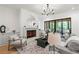 Inviting living room boasts a fireplace, large windows, and hardwood floors, creating a warm and elegant ambiance at 2461 Fernleaf Nw Ct, Atlanta, GA 30318