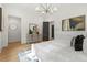 Bright main bedroom features modern chandelier, dresser, ensuite access and neutral decor at 2461 Fernleaf Nw Ct, Atlanta, GA 30318
