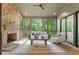 Relaxing screened-in porch with a brick fireplace and comfortable seating offers a serene outdoor living space at 2461 Fernleaf Nw Ct, Atlanta, GA 30318