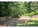 Private backyard with a fire pit and mature trees, ideal for enjoying peaceful evenings outdoors at 3381 Birchwood Trl, Snellville, GA 30078