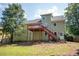 View of the home's backyard with a deck, stairs, and lush green lawn at 3381 Birchwood Trl, Snellville, GA 30078