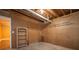 Unfinished basement featuring open ceiling with exposed pipes and a small wooden bookshelf at 3381 Birchwood Trl, Snellville, GA 30078