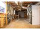 Spacious unfinished basement showcasing exposed utilities and a window, offering potential for development at 3381 Birchwood Trl, Snellville, GA 30078