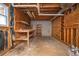 Partially finished basement with open ceiling and a workbench area, perfect for a workshop or storage at 3381 Birchwood Trl, Snellville, GA 30078