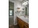 Bathroom vanity with sink, framed mirror, shelves, and wood cabinets at 3381 Birchwood Trl, Snellville, GA 30078