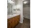 Well-lit bathroom features vanity with sink and mirror and shower-tub combo at 3381 Birchwood Trl, Snellville, GA 30078