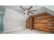 Bedroom featuring carpet, wooden accent wall, ceiling fan and ensuite bathroom at 3381 Birchwood Trl, Snellville, GA 30078