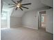 Neutral toned bedroom with large ceiling fan, carpeted floors and ensuite bathroom at 3381 Birchwood Trl, Snellville, GA 30078