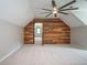 Bedroom featuring carpet, wooden accent wall, ceiling fan and ensuite bathroom at 3381 Birchwood Trl, Snellville, GA 30078