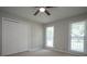 Comfortable bedroom with carpeted floors, two windows, ceiling fan, and spacious double closet at 3381 Birchwood Trl, Snellville, GA 30078