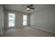 Inviting bedroom with plush carpet, neutral walls, two windows, and ceiling fan at 3381 Birchwood Trl, Snellville, GA 30078