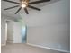 Neutral toned bedroom with large ceiling fan, carpeted floors and ensuite bathroom at 3381 Birchwood Trl, Snellville, GA 30078