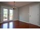 Dining room featuring French doors to the deck and sleek wood flooring at 3381 Birchwood Trl, Snellville, GA 30078