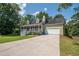 Charming home with a welcoming front porch, lush lawn, and an attached two-car garage at 3381 Birchwood Trl, Snellville, GA 30078
