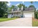 Inviting exterior of home featuring a covered porch and convenient two-car garage at 3381 Birchwood Trl, Snellville, GA 30078