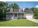 Charming home featuring a quaint front porch, well-maintained lawn, and attached two-car garage at 3381 Birchwood Trl, Snellville, GA 30078