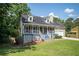 Inviting home featuring a front porch, shutters, a lush lawn, and an attached two-car garage at 3381 Birchwood Trl, Snellville, GA 30078