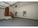 Spacious two-car garage with painted floor, stairs to the house, and natural light at 3381 Birchwood Trl, Snellville, GA 30078