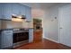 Stylish kitchen boasts stainless steel appliances, stone countertops, and view to living room fireplace at 3381 Birchwood Trl, Snellville, GA 30078
