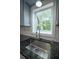 Kitchen with a stainless steel sink, granite countertops, subway tile backsplash, and window at 3381 Birchwood Trl, Snellville, GA 30078
