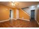 Living room with wood floors, ceiling fan, doors, and access to stairs at 3381 Birchwood Trl, Snellville, GA 30078