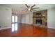 Bright living room featuring a stone fireplace, wood floors, and access to the deck at 3381 Birchwood Trl, Snellville, GA 30078