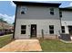 Backyard of a home with gray siding, and a newly installed concrete patio at 1119 Lockhart Way, Douglasville, GA 30135