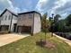 Exterior shot showcasing a well-maintained lawn and an attached two-car garage at 1119 Lockhart Way, Douglasville, GA 30135