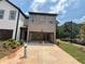 Exterior view of the attached two-car garage with concrete driveway and grassy front yard at 1119 Lockhart Way, Douglasville, GA 30135