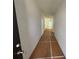 Hallway view leading to a bright living area, floored with protective covering during construction at 1119 Lockhart Way, Douglasville, GA 30135